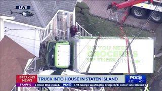 Truck crashes into house in Staten Island