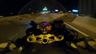 Motorcycle riders racing through tollway at night