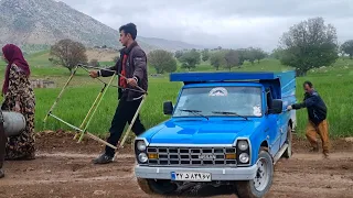 The car got stuck on the dirt road due to rain and Abbas bought a four-legged base from the market.