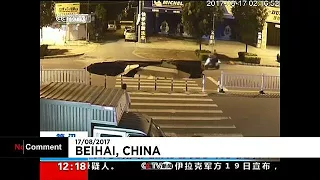 Moped rider falls down sinkhole in china