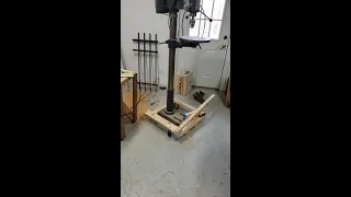 Retractable wheels for Drill Press using hinged casters and foot operated lifting lever