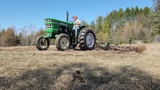 Oliver 1355 tractor with the John Deere cart spring tooth harrow.