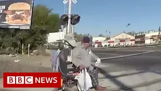 Officer saves man stuck on train tracks - BBC News