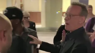 VIDEO: Tom Hanks Yells "Back The F**k Off" at Unruly Fans Who Bump Into His Wife