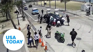 Heroic onlookers lift car to free trapped motorcyclist | USA TODAY