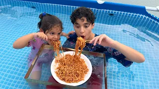 Children eat in the pool