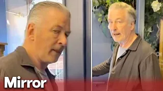 Angry Alec Baldwin slaps protester's phone