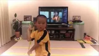 my son acting Bruce Lee's Game Of Death  Nunchaku