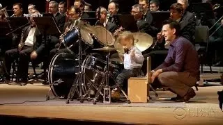 Watch: Toddler drummer lead an orchestra of adults