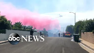 Firefighters wage battle against growing Southern California fires