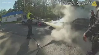 Atlanta police officers save man from burning car