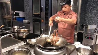 Chef Jian Chit Ming prepares his famous pigeon at 2 Michelin star Canton 8 in Shanghai, China