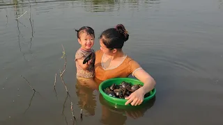 Single mother and daughter collect snails to sell and buy toys for her daughter