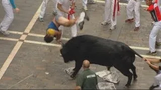 Excruciating moment a bull-runner gets gored at Pamplona in Spain