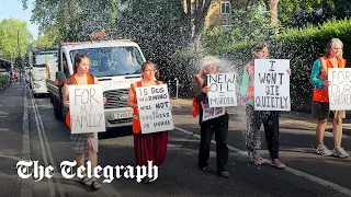 Just Stop Oil protesters soaked as water is thrown on them