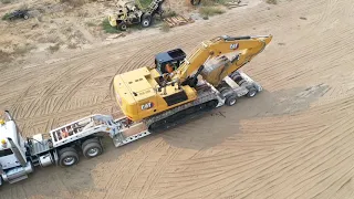 Getting a 336 excavator unloaded over the back of a Cozad trailer