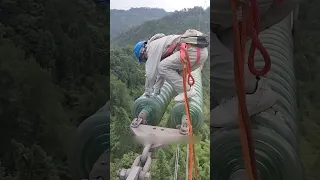 breaking glass insulator at high voltage tower