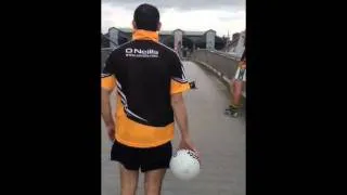 Alan Brogan Kicks a Ball Over the Liffey