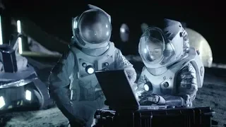 Two Astronauts Wearing Space Suits Work on a Laptop Exploring Newly Discovered Planet | Stock