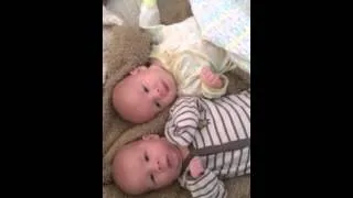 Identical twin boys sneezing