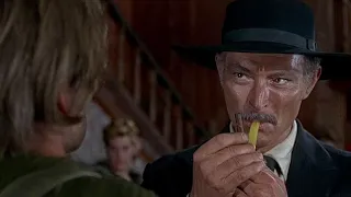 For a few dollars more (1965). Mortimer (Lee Van Cleef) lights a match on Juan Salvaje's back