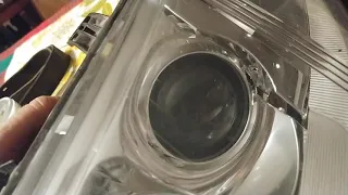 cleaning internal projector lens in a car headlight using a cotton swab