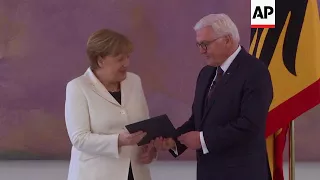 German president officially appoints Merkel as chancellor