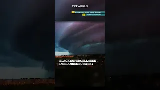 Black supercell hovers in sky above Brandenburg