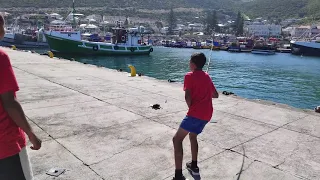 Little boy catches an octopus on the pier in Kalk Bay, Western Cape South Africa.