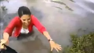 Woman Trys To Cross Flooded Road