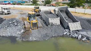 Dump Truck Transport Stone Filling Lake Stuck in the Deep Hole Recovery by Bulldozer and WheelLoader