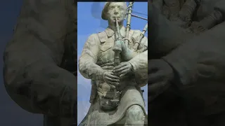 A bagpiper plays on Sword beach