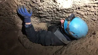 Scott squeezing through Rat Hole at Dead Horse Cave - part #1