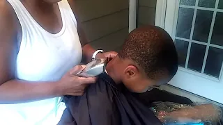 Mom cutting son's hair