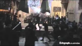 Rival clergymen fight with brooms at Church of the Nativity