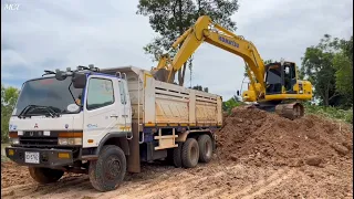 Komatsu Pc200-10CE Loading into a dump truck  It's a very good load.