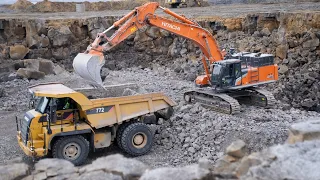 Hitachi 490 Loading Cat trucks