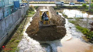 Smartest expert driver smooth cutting rock drop down in water for road making by dozer truck dump