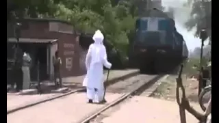 Daring old man standing in front of running train