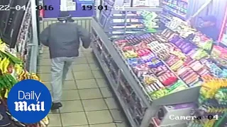 Terrifying CCTV shows armed robbers storming newsagents - Daily Mail