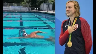 Five-time Olympic champion Katie Ledecky swims the length of a pool with CHOCOLATE MILK on her head