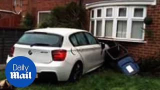 BMW smashes into front of house hospitalising man lying on sofa - Daily Mail