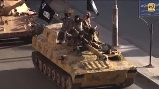 Islamic State militants parade in their Syrian stronghold