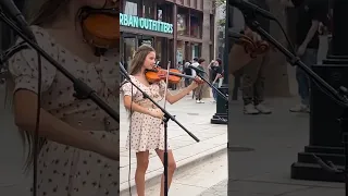 Karolina Protsenko tunes her violin before Stand by Me Violin Cover
