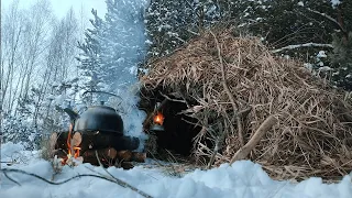 Winter adventure in the wild forest. Building of a cozy shelter. Winter overnight hike