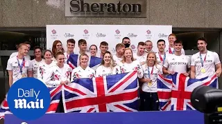 Team GB swimmers arrive back in the UK after hitting medal record