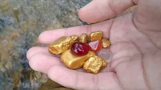 found a treasure trove of gold and crystal stones sunken in a former mining river