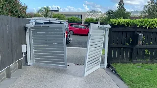 Double swing louvered gate with rising hinges automated by Dudleys (New Zealand)#swinggateopeners