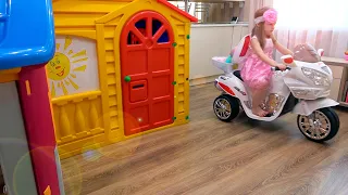 Eva playing with funny playhouses toys