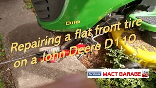 Repairing a flat front tire on a John Deere D110